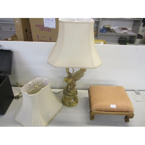 108 - A brass coloured table lamp in the form of an eagle with outstretched wings, perched on a rocky base... 