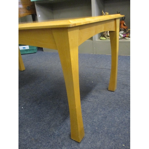 109 - A contemporary light wood coffee table with bird's eye maple veneered top, standing on four slightly... 
