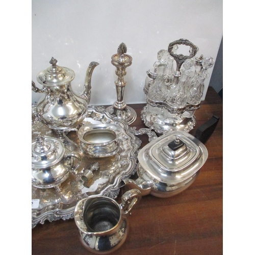 115 - A selection of silver plate to include an ornate twin handled tray, coffee/tea services, candlestick... 