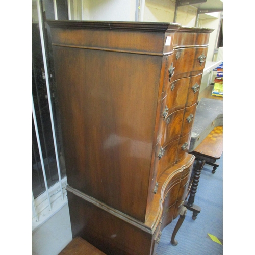 122 - A Queen Anne style figured walnut chest on stand having a stepped cornice above six drawers with a b... 