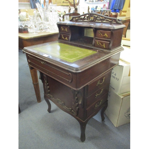 75 - A late 19th/early 20th century mahogany Davenport having a pierced raised back with a green leather ... 