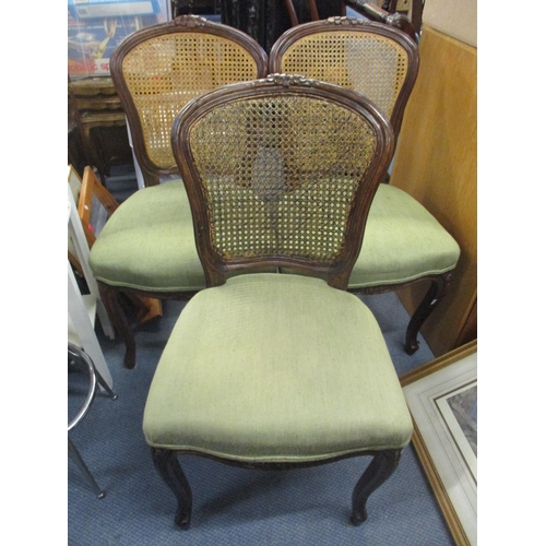 94 - A set of six oak cane back dining chairs with carved floral top rails and on cabriole legs, two bein... 