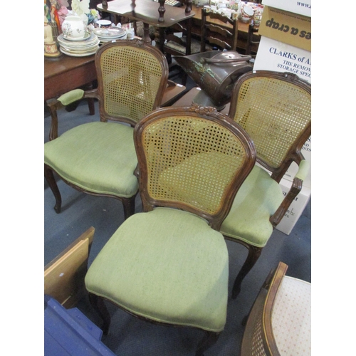 94 - A set of six oak cane back dining chairs with carved floral top rails and on cabriole legs, two bein... 