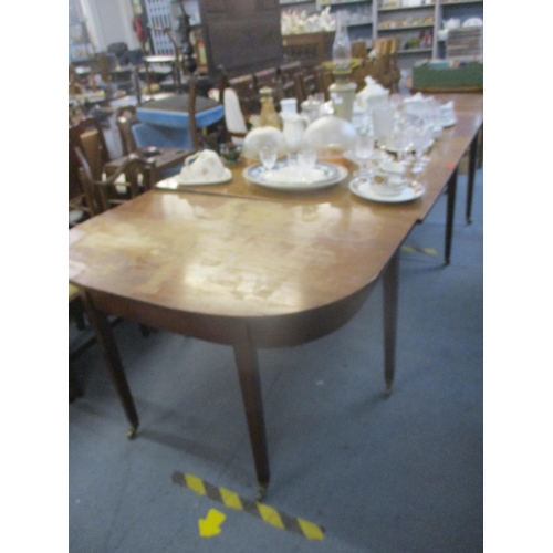 404 - A Georgian mahogany drop flap D-end dining table on square tapering legs, brass cup and castors 73cm... 