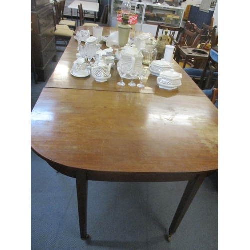 404 - A Georgian mahogany drop flap D-end dining table on square tapering legs, brass cup and castors 73cm... 