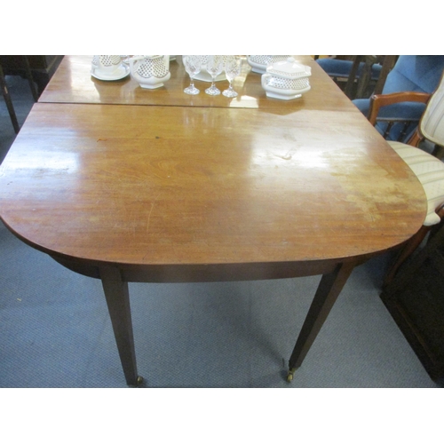 404 - A Georgian mahogany drop flap D-end dining table on square tapering legs, brass cup and castors 73cm... 