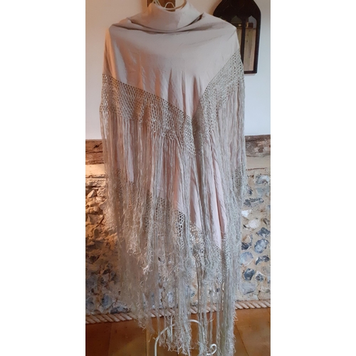 4 - An early 20th Century cream silk tasselled shawl having a hand-crotchet triple band surround with ex... 