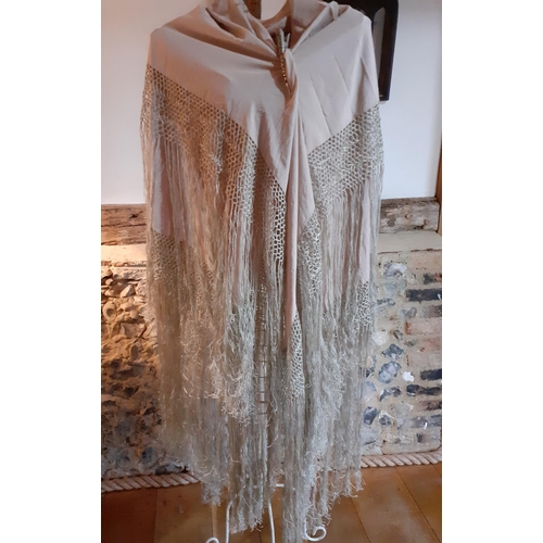 4 - An early 20th Century cream silk tasselled shawl having a hand-crotchet triple band surround with ex... 