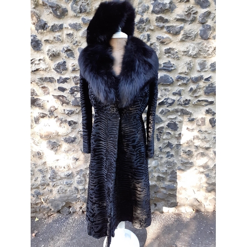 39 - An Alan Fischelis black shearling and rabbit hair three-quarter length coat, UK size 10/12 having an... 