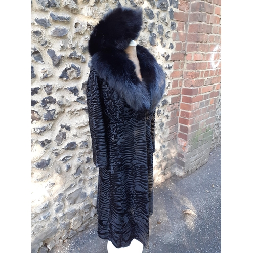 39 - An Alan Fischelis black shearling and rabbit hair three-quarter length coat, UK size 10/12 having an... 