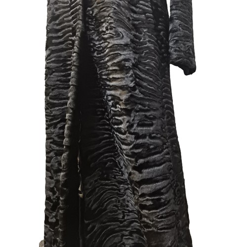 39 - An Alan Fischelis black shearling and rabbit hair three-quarter length coat, UK size 10/12 having an... 