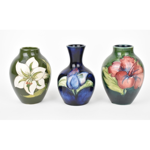 166 - A small collection of Moorcroft ceramic vases, to include 'Hibiscus', 'Bermuda Lily' and 'Bougainvil... 