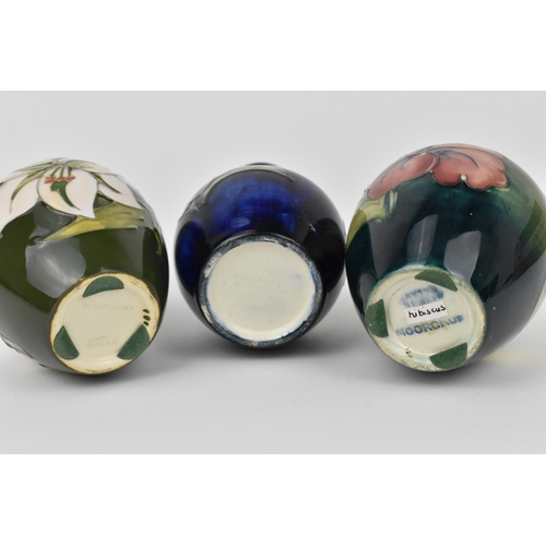 166 - A small collection of Moorcroft ceramic vases, to include 'Hibiscus', 'Bermuda Lily' and 'Bougainvil... 