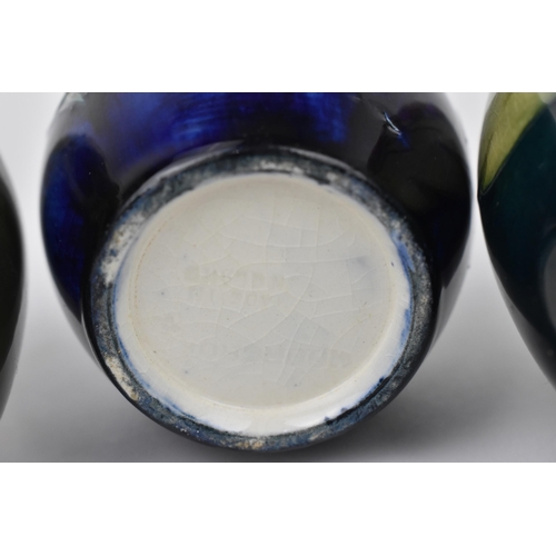 166 - A small collection of Moorcroft ceramic vases, to include 'Hibiscus', 'Bermuda Lily' and 'Bougainvil... 