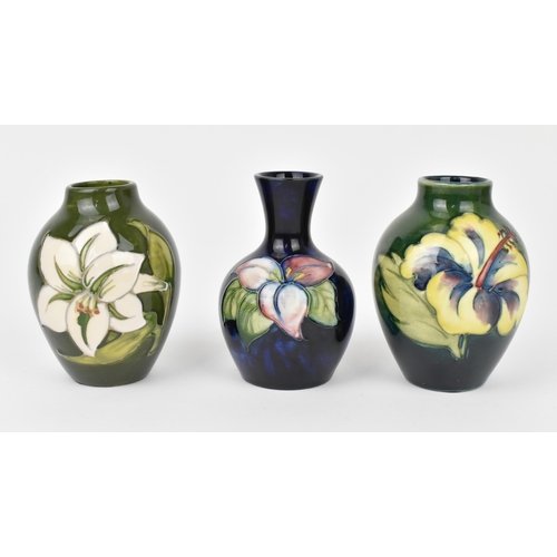 166 - A small collection of Moorcroft ceramic vases, to include 'Hibiscus', 'Bermuda Lily' and 'Bougainvil... 