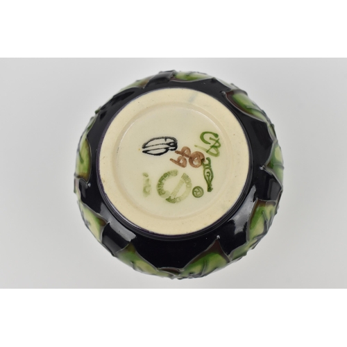 168 - A small collection of Moorcroft ceramics, to include a squat vase in the 'Clematis' pattern on green... 