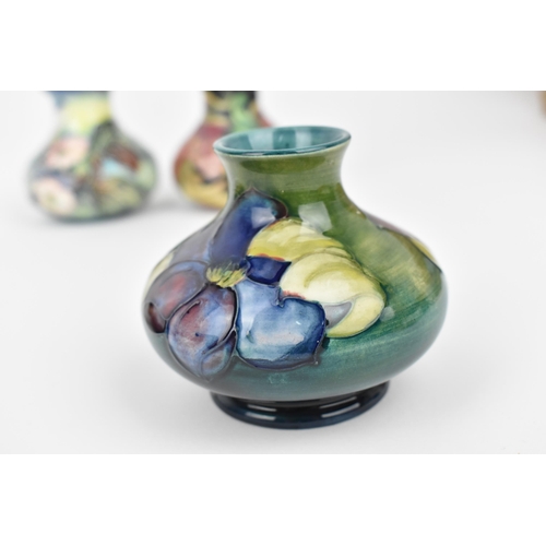 168 - A small collection of Moorcroft ceramics, to include a squat vase in the 'Clematis' pattern on green... 