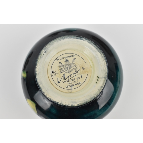 168 - A small collection of Moorcroft ceramics, to include a squat vase in the 'Clematis' pattern on green... 