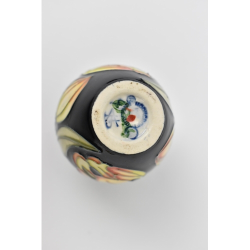 168 - A small collection of Moorcroft ceramics, to include a squat vase in the 'Clematis' pattern on green... 