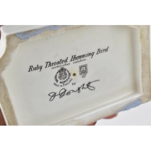 172 - A pair of Royal Worcester models of Ruby-throated hummingbirds on fuschias by James Alder, one with ... 