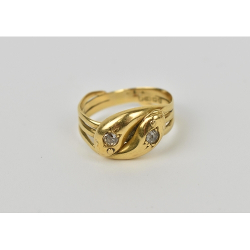 175 - An 18ct yellow gold and diamond double snake ring, modelled as two entwined serpents, each head inse... 