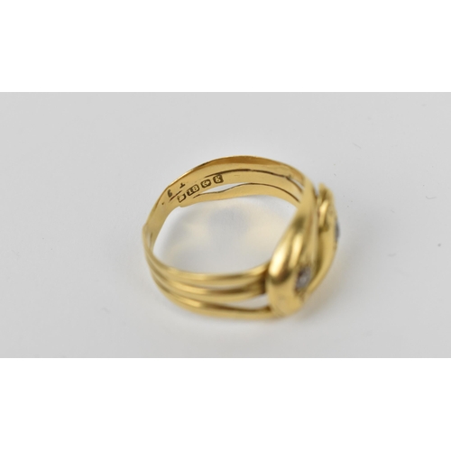 175 - An 18ct yellow gold and diamond double snake ring, modelled as two entwined serpents, each head inse... 