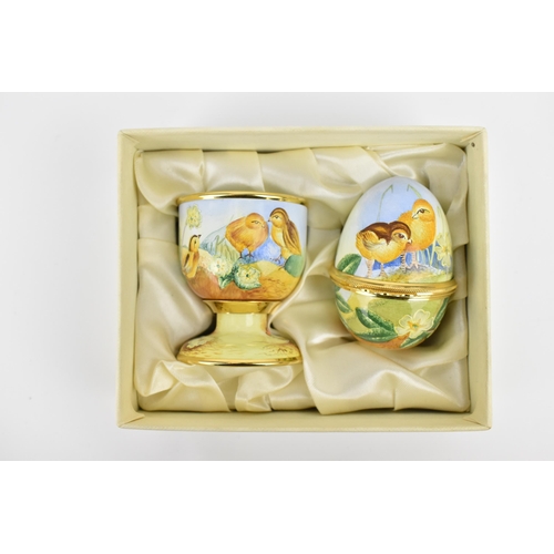 134 - A limited edition Moorcroft Enamels Ltd 'First Steps' egg cup and hinged egg painted by Marie Graves... 