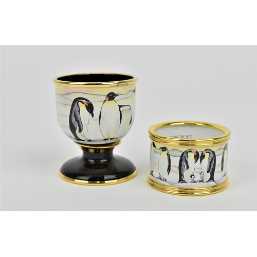 139 - A Moorcroft Enamels Ltd Penguin family pattern egg cup and napkin ring set, designed by Amanda Rose,... 