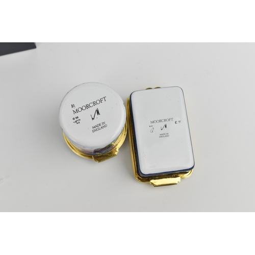 145 - Two Moorcroft Enamels Ltd hinged boxes to include one painted by E. Todd, depicting a water landscap... 