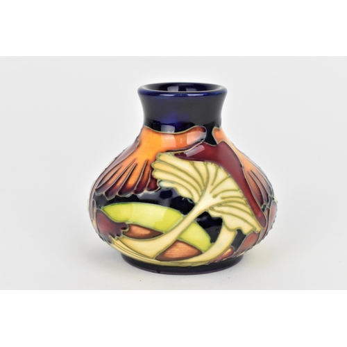 147 - A Moorcroft 2005 'Parasol Dance' pattern vase of squat form, with tubeline decoration, designed by K... 
