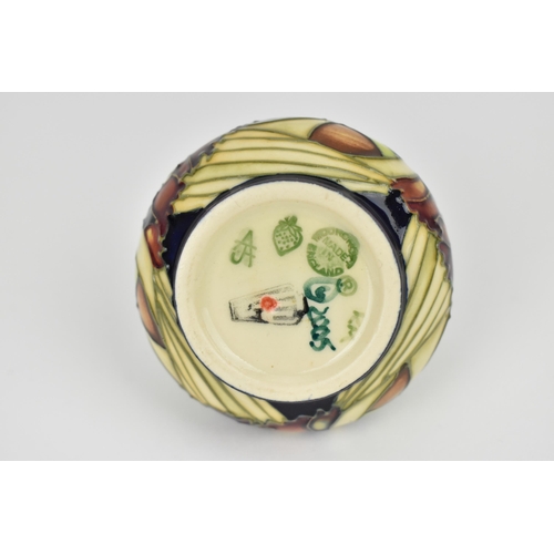 147 - A Moorcroft 2005 'Parasol Dance' pattern vase of squat form, with tubeline decoration, designed by K... 