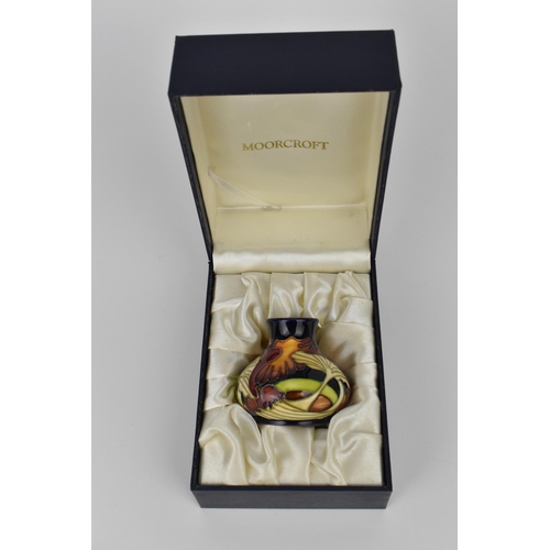 147 - A Moorcroft 2005 'Parasol Dance' pattern vase of squat form, with tubeline decoration, designed by K... 