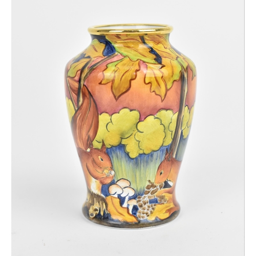 155 - A Moorcroft Enamels Ltd miniature baluster vase, painted with squirrels foraging, with artists initi... 