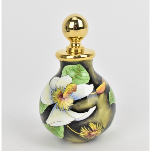 157 - A Moorcroft Enamels Ltd perfume bottle with gilt stopper, designed by Philip Gibson and painted by E... 
