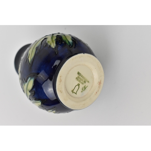 163 - A Moorcroft pottery 'Buttercup' pattern cup and saucer designed by Sally Tuffin, together with a mat... 