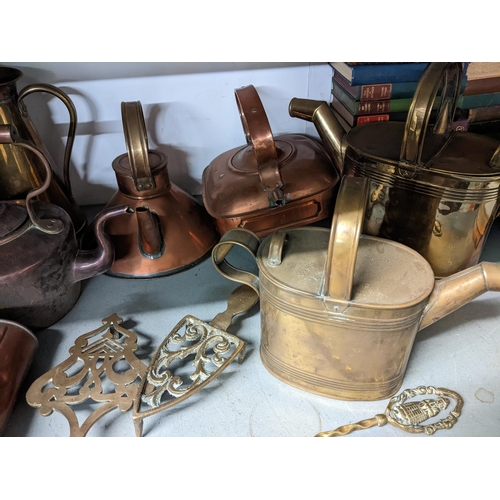 120 - Brass and copper to include kitchenalia, kettle maids, watering cans, trivets, a hot water bottle an... 