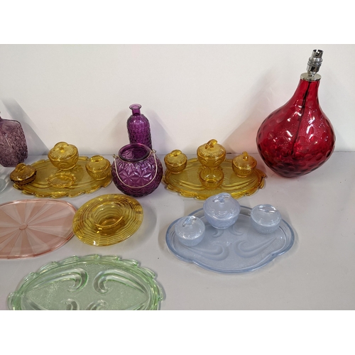 82 - Glassware to include a red dimpled lamp dressing table sets, a pair of purple decanters, pedestal gl... 