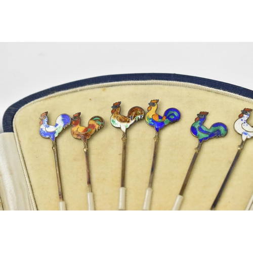 129 - A cased set of six Art Deco sterling silver and enamel cocktail sticks with cockerel finials, in fit... 