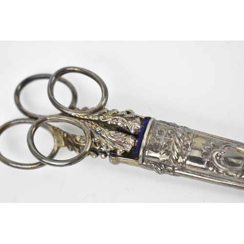 132 - A pair of Victorian silver mounted scissors, Birmingham 1892, in fitted embossed case with smaller p... 