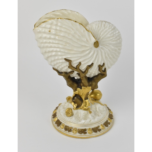 136 - A late 19th century Royal Worcester nautilus spoon warmer of ivory ground with gilt border, on a nat... 