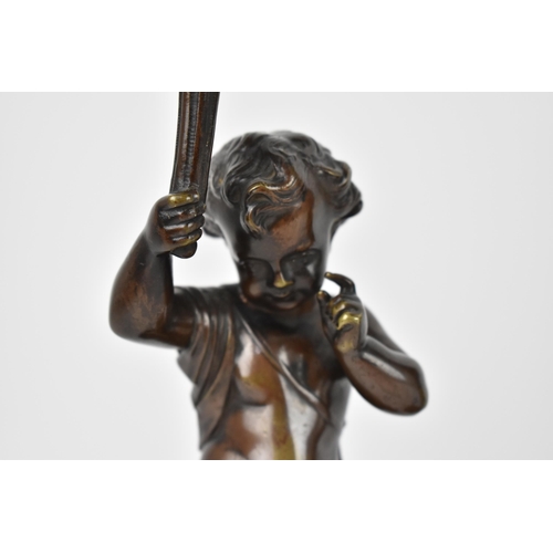 137 - A pair of late 19th century patinated bronze figural lamps, each modelled as a putto holding the lig... 