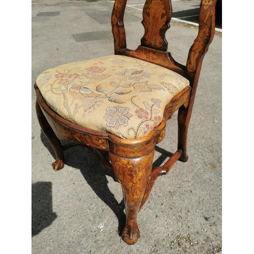 141 - A pair of 18th century Dutch walnut and marquetry high back dining chairs, the inlaid splat depictin... 