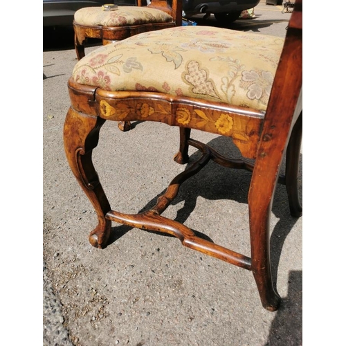 141 - A pair of 18th century Dutch walnut and marquetry high back dining chairs, the inlaid splat depictin... 