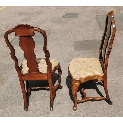 141 - A pair of 18th century Dutch walnut and marquetry high back dining chairs, the inlaid splat depictin... 