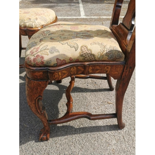 141 - A pair of 18th century Dutch walnut and marquetry high back dining chairs, the inlaid splat depictin... 