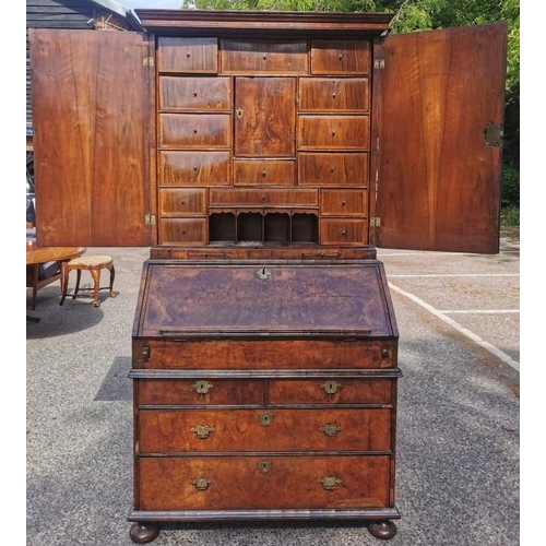 142 - An early 18th century burr walnut bureau cabinet, circa 1720, in the manner of Coxed and Woster, the... 