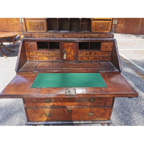 142 - An early 18th century burr walnut bureau cabinet, circa 1720, in the manner of Coxed and Woster, the... 