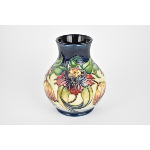 50 - A Moorcroft pottery 'Anne Lily' baluster vase, designed by Nicola Slaney, with tubelined floral deco... 