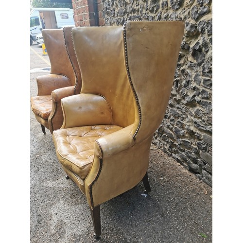 161 - A pair of George III design barrel back armchairs, upholstered in studded tan leather, with button s... 