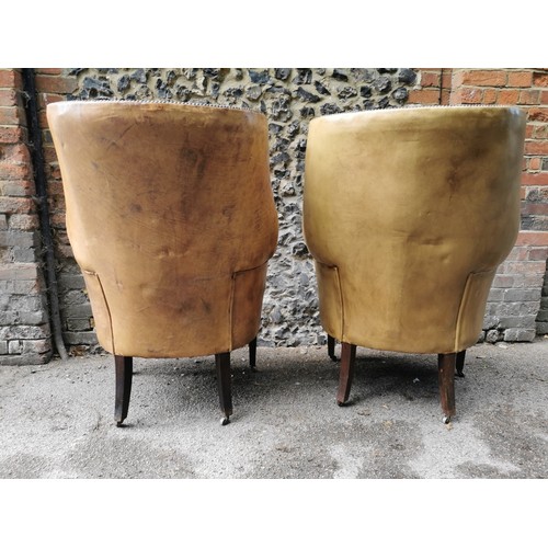 161 - A pair of George III design barrel back armchairs, upholstered in studded tan leather, with button s... 